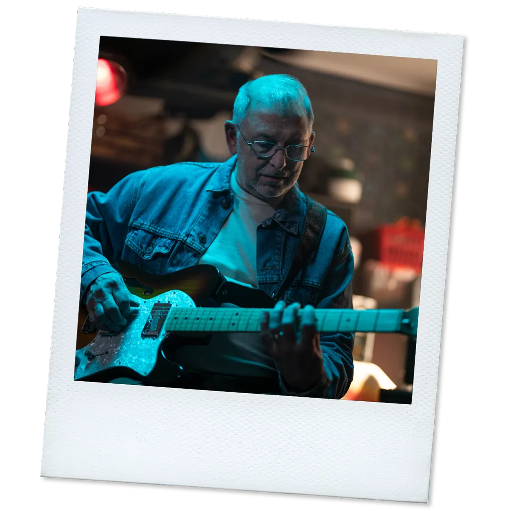 Polaroid of Rick, a real TAVR patient, playing the guitar