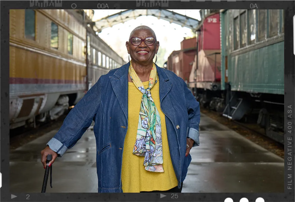 Snapshot of Joy, a real TAVR patient, standing in a train station